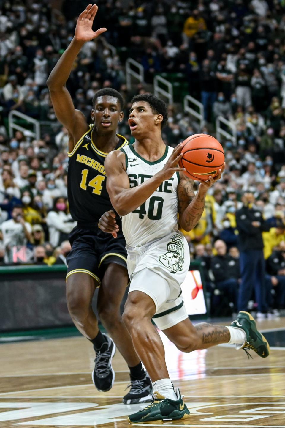 Michigan State's Keon Coleman, right, drives to the basket as Michigan's Moussa Diabate defends during the second half on Saturday, Jan. 29, 2022, at the Breslin Center in East Lansing.