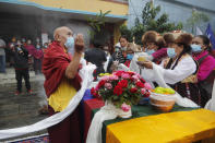 Friends and family members participate in the funeral of veteran Nepalese Sherpa guide Ang Rita, in Kathmandu, Nepal, Wednesday, Sept. 23, 2020. Ang Rita, who was the first person to climb Mount Everest 10 times has died Monday at age 72 after a long illness. (AP Photo/Niranjan Shrestha)