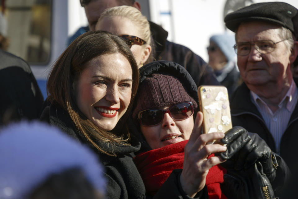 Finnish Prime Minister and chairperson of the Social Democratic Party (SDP) Sanna Marin poses for a selfie during a campaign event at the Tammela market square, in her hometown Tampere, Finland, April 1, 2023, ahead of the parliamentary elections day on Sunday, 2nd of April. (Kalle Parkkinen/Lehtikuva via AP)