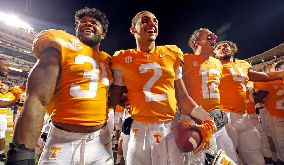 Tennessee quarterback Jarrett Guarantano (2) celebrates with teammates linebacker Darrin Kirkland Jr. (34), quarterback JT Shrout (12), and tight end Dominick Wood-Anderson (4) an NCAA college football game against Kentucky Saturday, Nov. 10, 2018, in Knoxville, Tenn. Tennessee won 24-7. (AP Photo/Wade Payne)