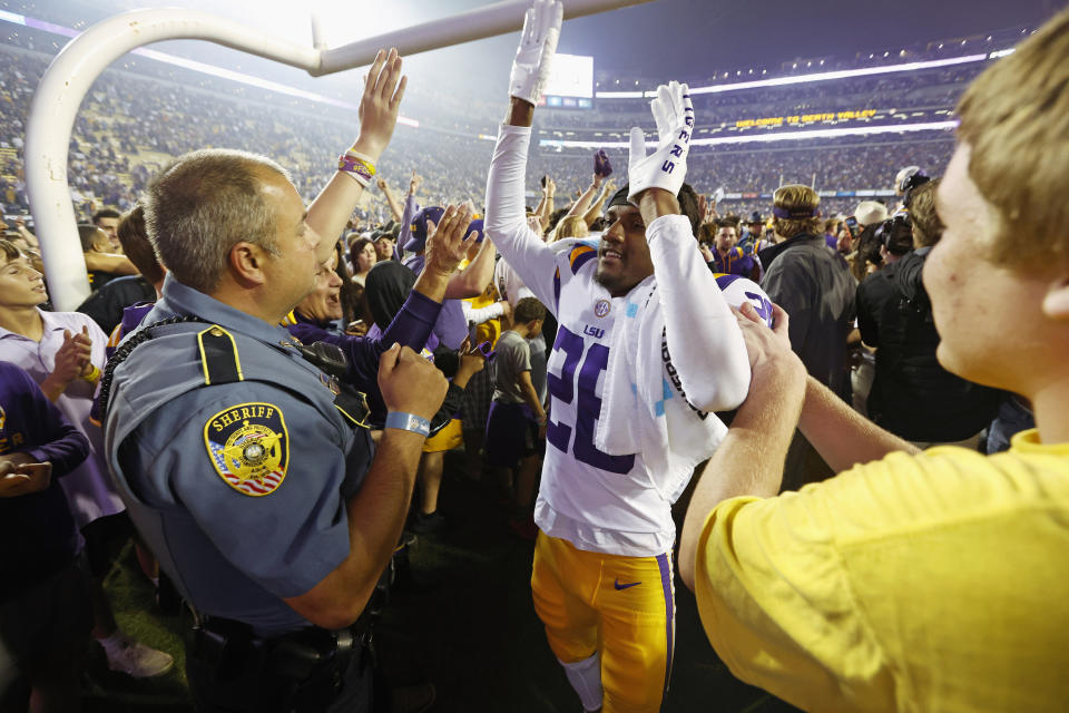 LSU cornerback Damarius McGhee (26) celebrates with fans who stormed the field after an NCAA college football game against Alabama in Baton Rouge, La., Saturday, Nov. 5, 2022. LSU won 32-31 in overtime. (AP Photo/Tyler Kaufman)