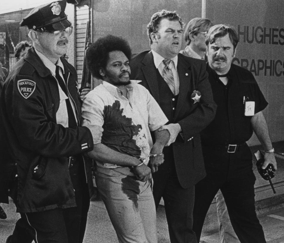 Convicted murderer Raymond Lee Stewart is escorted by officers after being recaptured after escaping police custody in this Dec. 31, 1989, file photo.