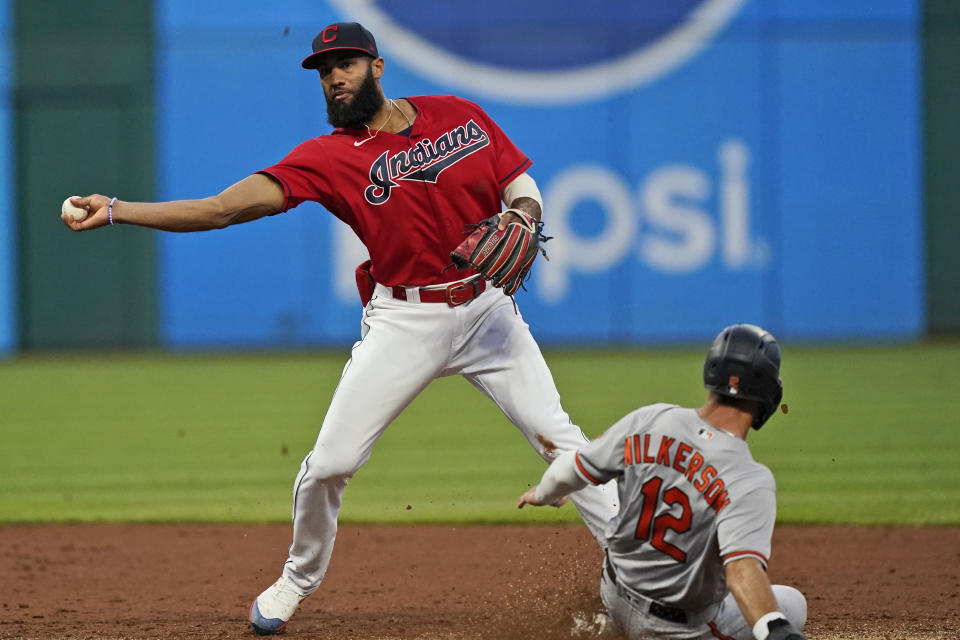 Cleveland Indians' Amed Rosario, left, gets Baltimore Orioles' Stevie Wilkerson at second base in the third inning of a baseball game, Monday, June 14, 2021, in Cleveland. Rosario was able to make the throw to get Orioles' Cedric Mullins at first base for a double play. (AP Photo/Tony Dejak)