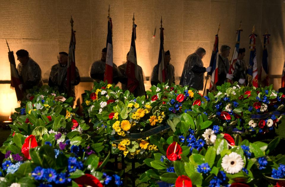 Flag bearers prepare near wreathes prior to a dawn service to mark the 100th anniversary of ANZAC (Australian and New Zealand Army Corps) Day at the Australian National Memorial in Villers-Bretonneux, in northern France, April 25, 2015. (REUTERS/Philippe Wojazer)