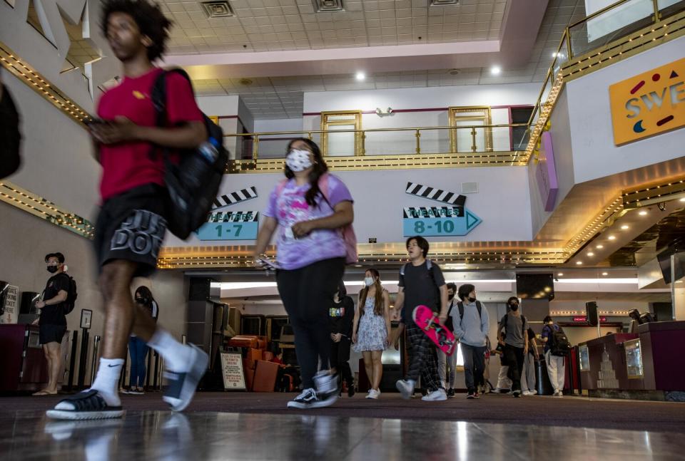 College students walk through the lobby of a movie theatre after attending class in Riverside.