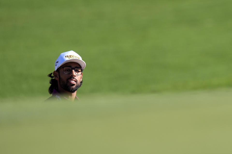 Akshay Bhatia watches his shot from the bunker on the second green during the third round of The Sentry golf event, Saturday, Jan. 6, 2024, at Kapalua Plantation Course in Kapalua, Hawaii. (AP Photo/Matt York)