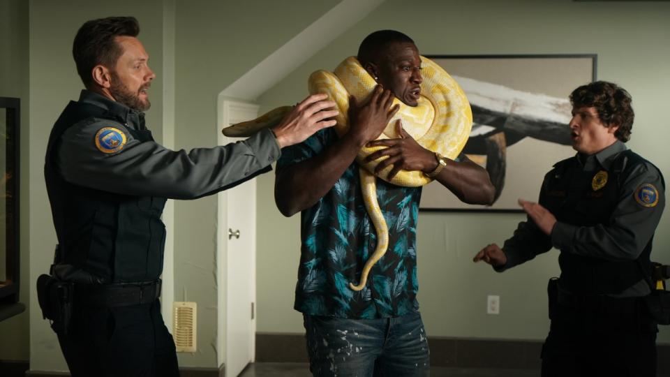 Frank and Fred helping man with snake around his neck in Animal Control