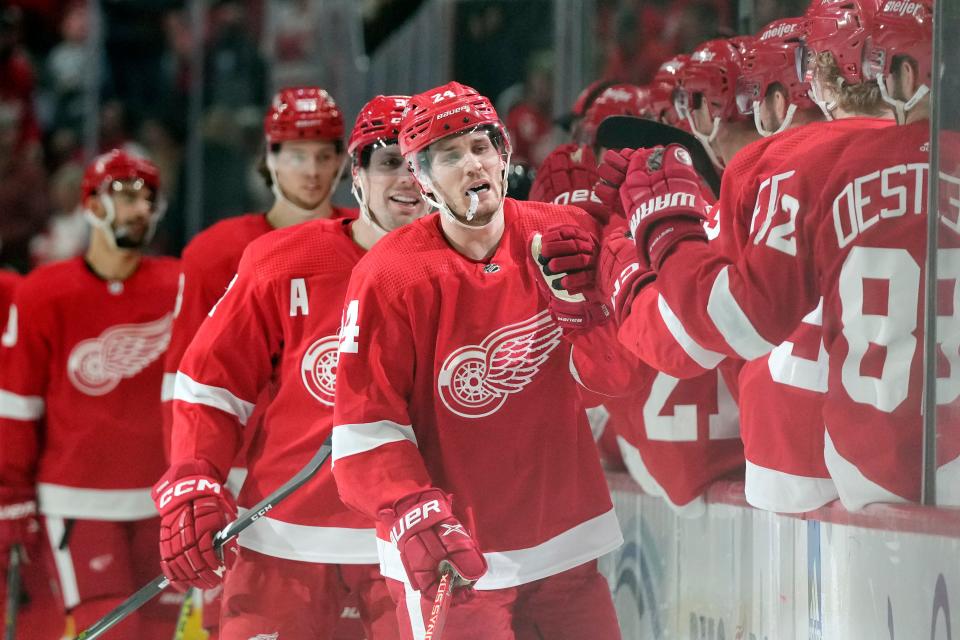 Red Wings center Pius Suter greets teammates after scoring during the first period on Monday, March 20, 2023, at Little Caesars Arena.