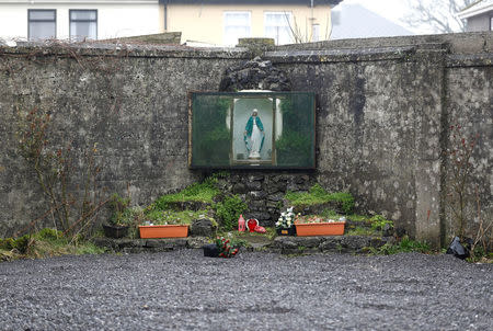 A shrine, with an image of the Virgin Mary, is seen in the corner of an enclosed area on part of the site of the former mother-and-baby home run by the Bon Secours nuns, where the remains of an unknown number of babies and toddlers were found buried, in Tuam, western Ireland March 7, 2017. REUTERS/Peter Nicholls