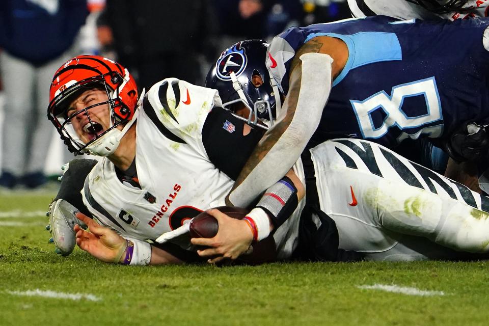 Cincinnati Bengals quarterback Joe Burrow (9) is sacked in the fourth quarter during an NFL divisional playoff football game against the Tennessee Titans, Saturday, Jan. 22, 2022, at Nissan Stadium in Nashville. The Cincinnati Bengals defeated the Tennessee Titans, 19-16, to advance to the AFC Championship game. 