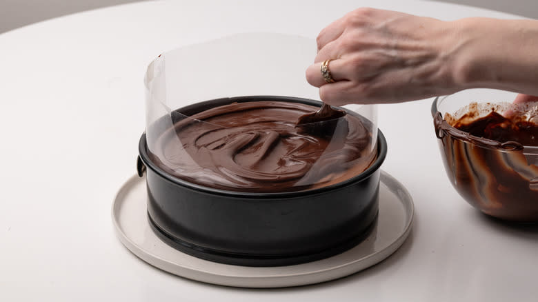 smoothing ganache over cake 