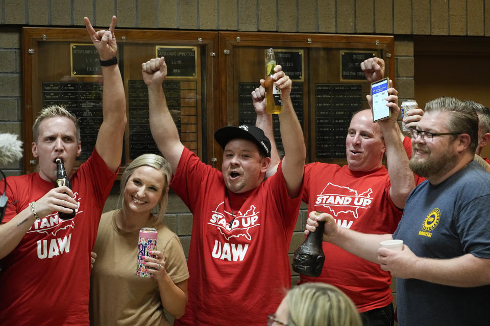 Volkswagen automobile plant employees celebrate as they watch the results of a UAW union vote, late Friday, April 19, 2024, in Chattanooga, Tenn. (AP Photo/George Walker IV)