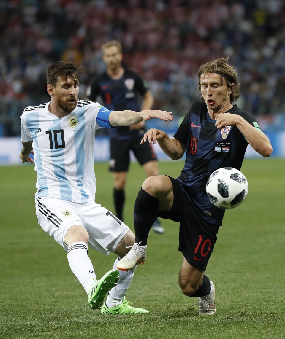 <p>Big guns: Two of the biggest names on the pitch, Lionel Messi and Luka Modric, go head to head. (AP) </p>