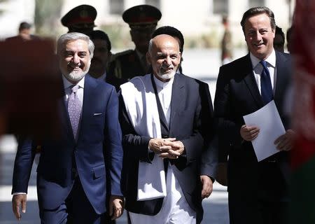 Britain's Prime Minister David Cameron (R), Afghanistan's President Ashraf Ghani (C) and Prime Minister Abdullah Abdullah arrive for a news conference in Kabul October 3, 2014. REUTERS/Omar Sobhani