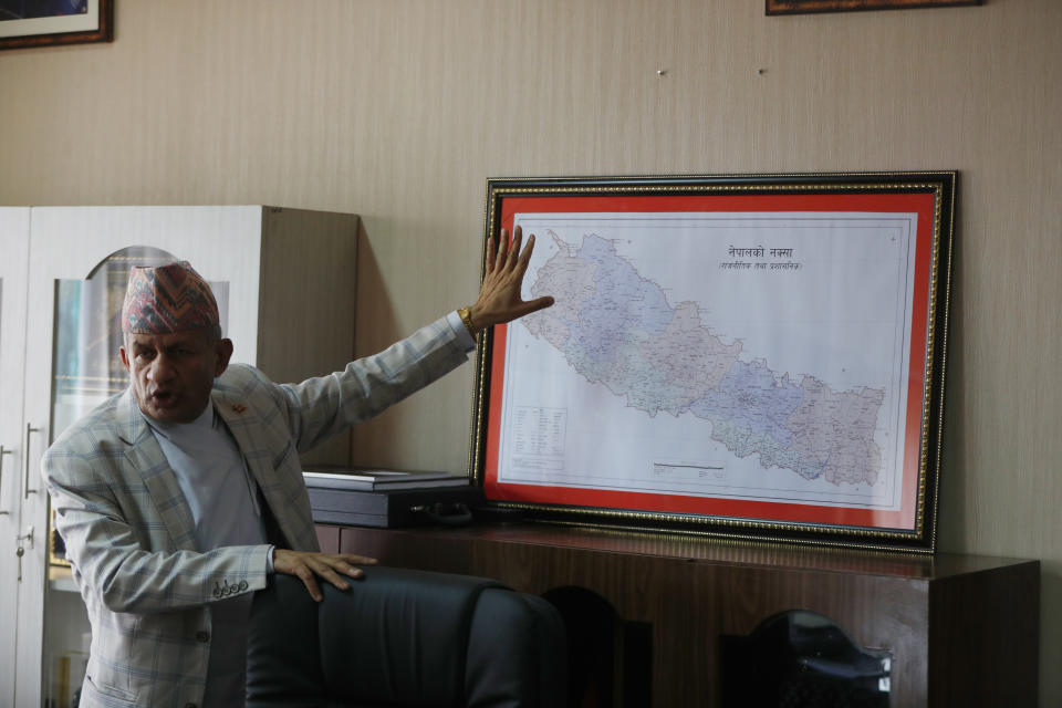 Nepal’s foreign minister Pradeep Gyawali points to a map of Nepal during an interview with the Associated Press in Kathmandu, Nepal, Tuesday, June 9, 2020. Gyawali said Tuesday that the country was still waiting for a response from India on holding talks to resolve a border dispute that has strained relations between the South Asian neighbors. (AP Photo/Niranjan Shrestha)