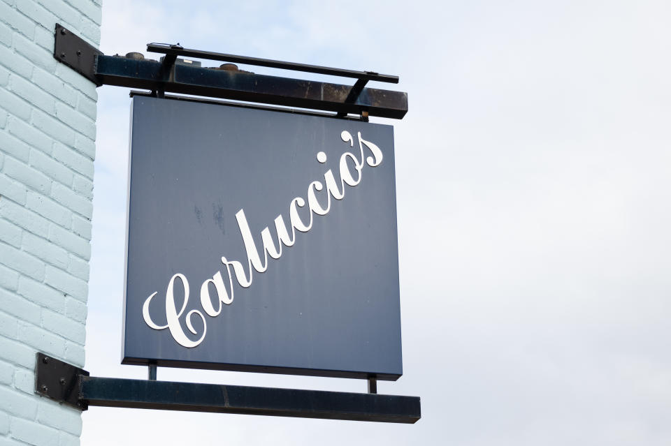 CARDIFF, WALES - MARCH 30: A close-up of a Carluccio's restaurant sign in Cardiff Bay on March 30, 2020, in Cardiff, Wales. Carluccio's has entered into administration due to problems made worse by the Coronavirus. The Italian restaurant chain has 71 restaurants across the UK and employs 2000 staff. The Coronavirus (COVID-19) pandemic has spread to many countries across the world, claiming over 35,000 lives and infecting hundreds of thousands more. (Photo by Matthew Horwood/Getty Images)