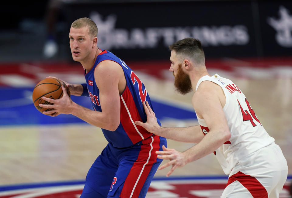 FILE - In this March 17, 2021, file photo, Detroit Pistons center Mason Plumlee is defended by Toronto Raptors center Aron Baynes during an NBA basketball game in Detroit. The Charlotte Hornets didn’t wait until the 11th pick in the NBA draft to address their biggest need, acquiring Plumlee and the No. 37 pick from the Detroit Pistons on Thursday night, July 29, a person familiar with the situation told The Associated Press. (AP Photo/Carlos Osorio, File)