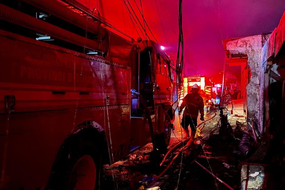 Firefighters extinguish fires that burn down homes of residents living nearby of the fire at the fuel depot owned by the state-owned oil and gas company Pertamina, in Plumpang, Jakarta, on 3 March 2023 (AFP via Getty Images)