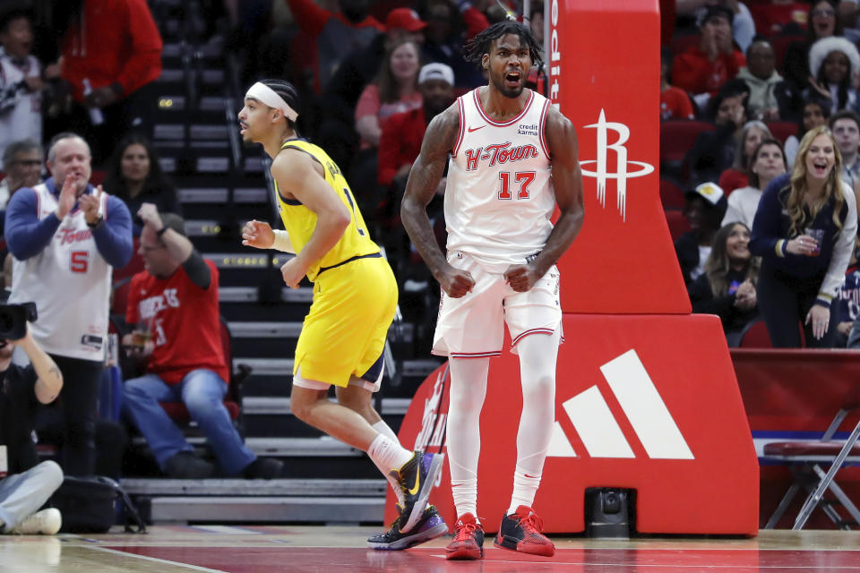 Houston Rockets forward Tari Eason (17) reacts after dunking against Indiana Pacers guard Andrew Nembhard, left, after a turnover during the first half of an NBA basketball game Tuesday, Dec. 26, 2023, in Houston. (AP Photo/Michael Wyke)