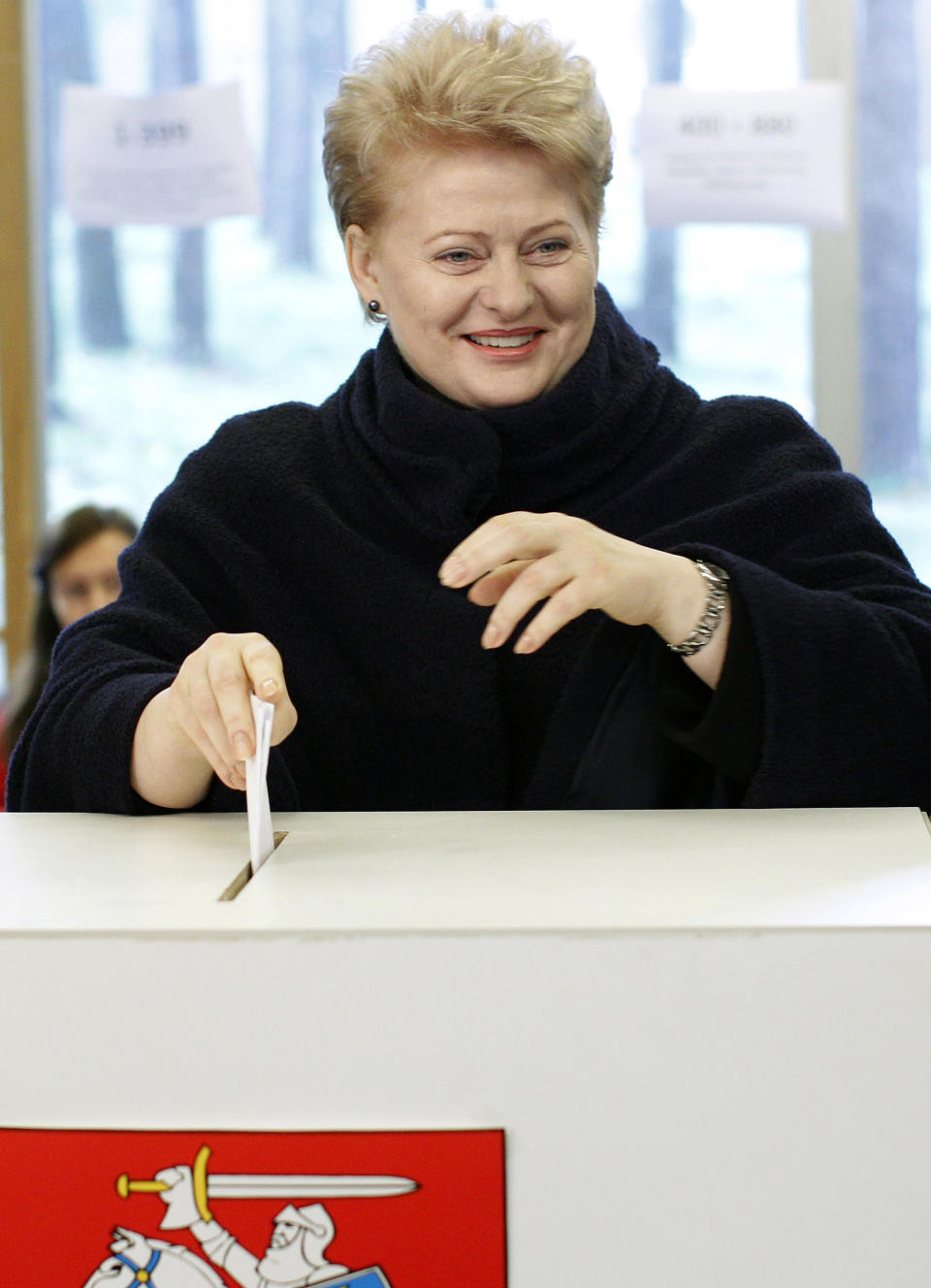 Lithuania's President Dalia Grybauskaite casts her ballot at a polling station in Vilnius, Lithuania, Sunday, Oct. 14, 2012. Lithuanians are expected to deal a double-blow to the incumbent conservative government in national elections Sunday by handing a victory to opposition leftists and populists and saying 'no' to a new nuclear power plant that supporters claim would boost the country's energy independence. (AP Photo/Mindaugas Kulbis)