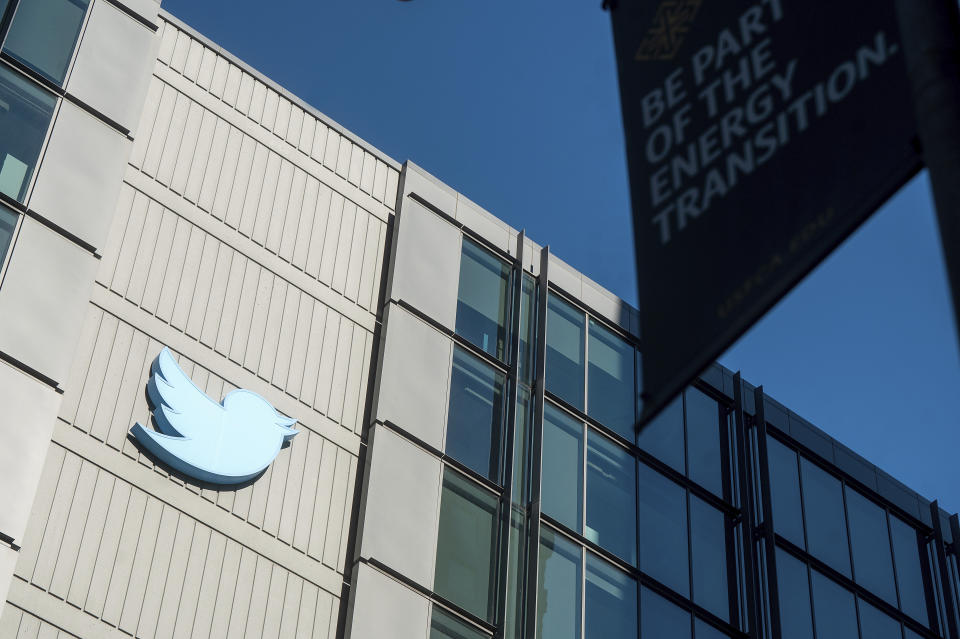 FILE - A Twitter logo hangs outside the company's San Francisco offices on Tuesday, Nov. 1, 2022. A German official who won a defamation case against Twitter this week has dedicated his legal victory to Dr. Anthony Fauci, the top U.S. infectious disease expert targeted by the microblogging site's new owner, Elon Musk. (AP Photo/Noah Berger, file)