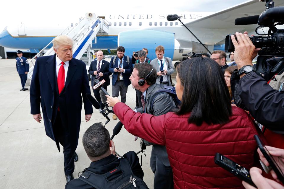 President Donald Trump takes questions from a gathering of reporters next to Air Force One at Lunken Airport in Cincinnati on Friday, Oct. 12, 2018. President Trump visited the Cincinnati area for a MAGA Rally at the Warren County Fair Grounds in Lebanon, Ohio, Friday night.