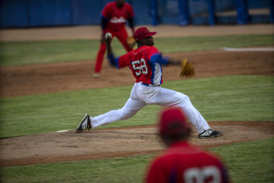 Cuba's pitcher Yoanni Yera Montalvo throws the ball during a training session at the Estadio Latinoamericano in Havana, Cuba, Tuesday, May 18, 2021. A little over a week after the start of the Las Americas Baseball Pre-Olympic in Florida, the Cuban team does not have visas to travel to the United States. (AP Photo/Ramon Espinosa)