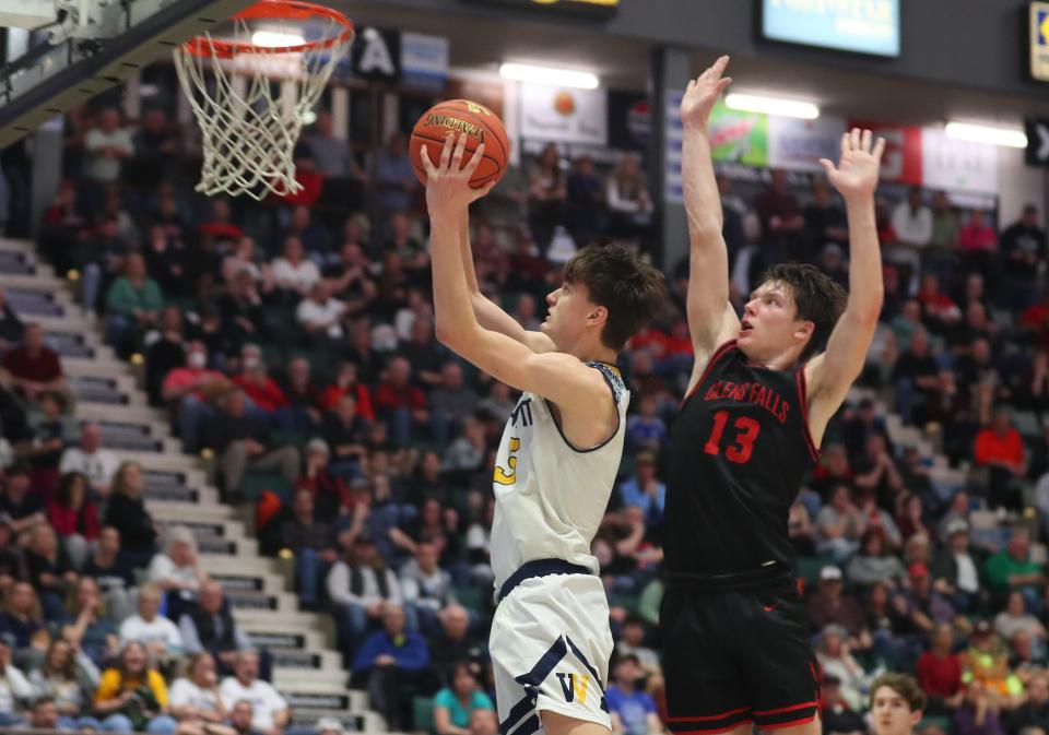 Wayne's Cam Blankenberg (5) drives to the basket against Glens Falls during the state championship game at the Cool Insuring Arena in Glens Falls, New York March 16, 2024. Glens Falls won the game 50-37.