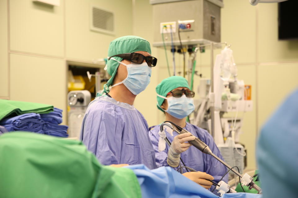 大腸直腸外科施廷翰醫師配戴3D偏光眼鏡，為患者進行3D立體腹腔鏡手術切除大腸腫瘤。