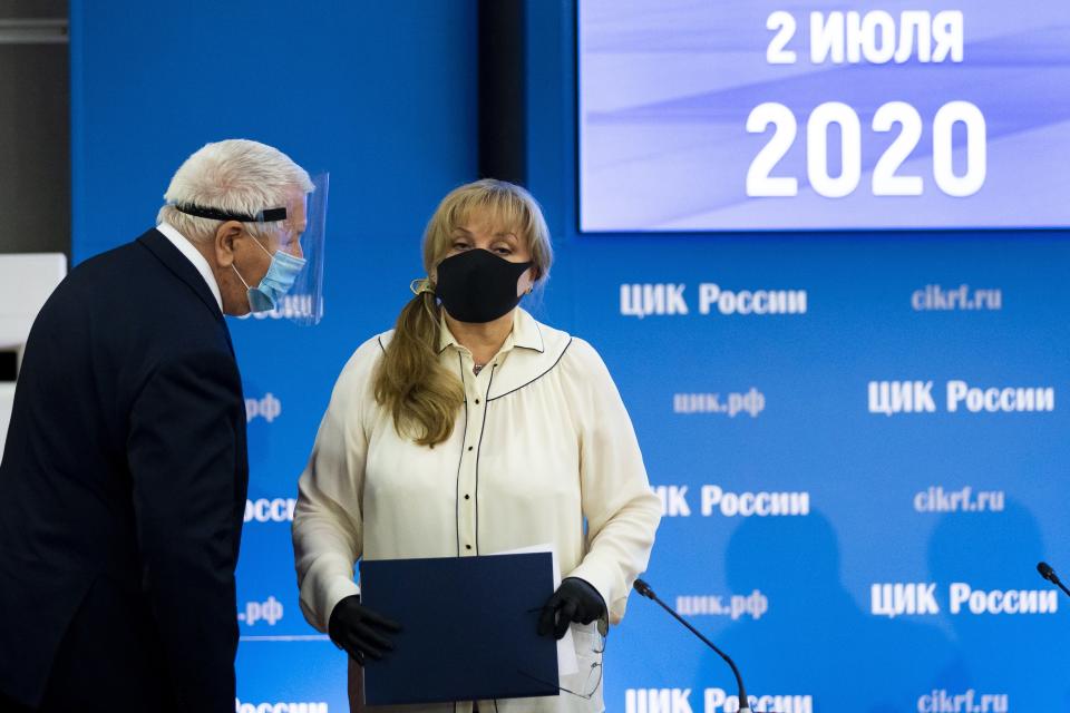 Ella Pamfilova, head of Russian Central Election Commission, wearing a face mask and gloves to protect against coronavirus, speaks to a member of the Central Election Commission after her news conference in Moscow, Russia, Thursday, July 2, 2020. Almost 78% of voters in Russia have approved amendments to the country's constitution that will allow President Vladimir Putin to stay in power until 2036, Russian election officials said Thursday after all the votes were counted. Kremlin critics said the vote was rigged. (AP Photo/Alexander Zemlianichenko)