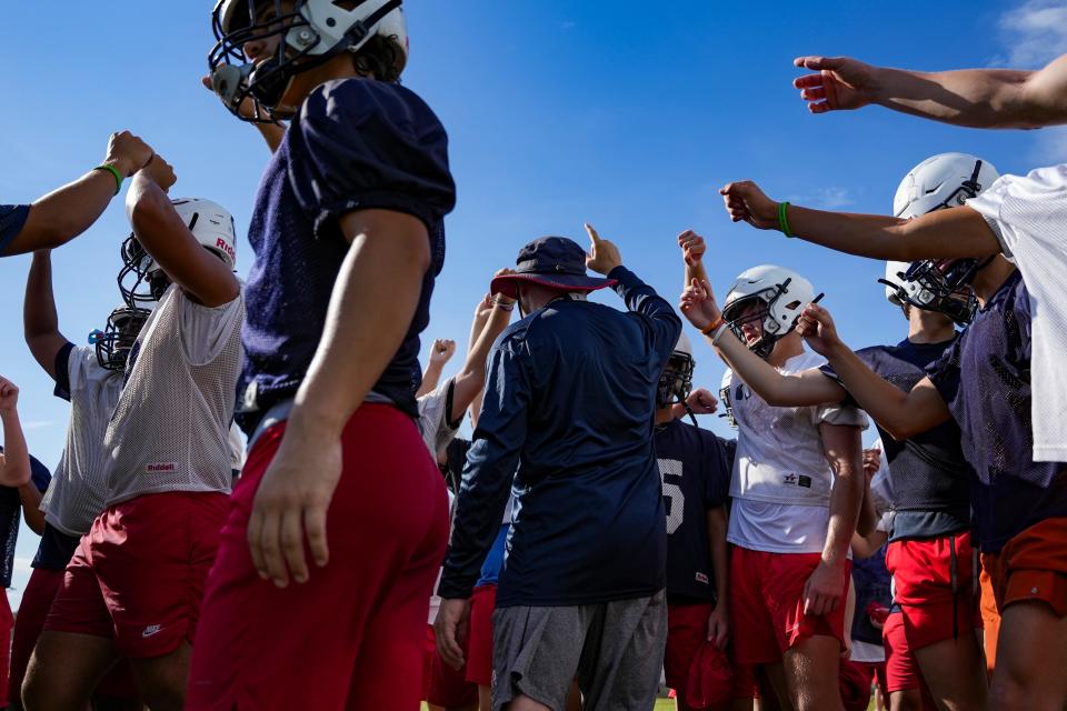 Football players take part in practice at Estero High School on Tuesday, Aug. 1, 2023.