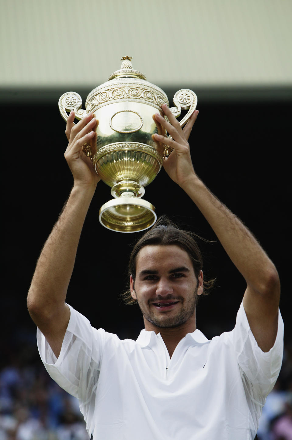 <p>Roger Federer of Switzerland holds the trophy after his victory over Mark Philippoussis of Australia in the Men’s Singles Final in July 2003. </p>