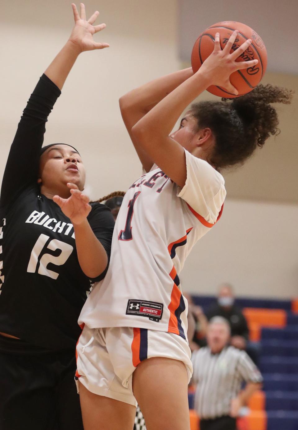 Buchtel's Aniya Howze-Blake defends as Ellet's Caitlyn Holmes shoots in the first half of Ellet's 63-24 win Monday night. [Mike Cardew/Beacon Journal]