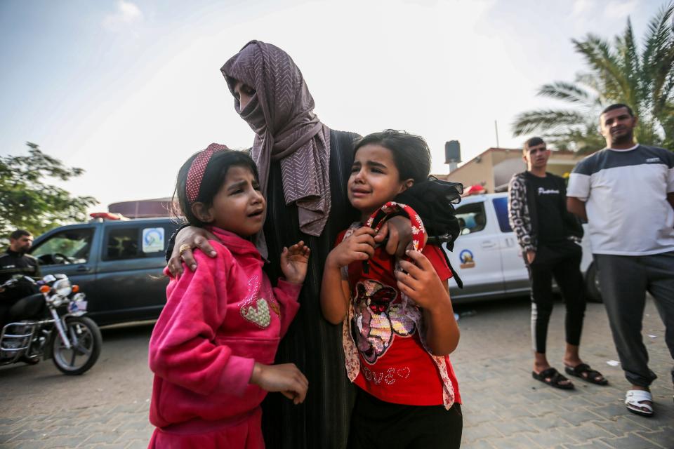 People mourn as they collect the bodies of Palestinians killed in Israeli air raids on Nov. 3 2023 in Khan Yunis, Gaza.