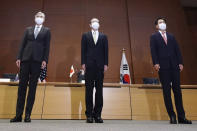 Japanese Foreign Ministry's Director-General of the Asian and Oceanian Affairs Bureau Takehiro Funakoshi, center, U.S. Special Representative for North Korea, Sung Kim, left, and South Korea's Special Representative for Korean Peninsula Peace and Security Affairs Noh Kyu-duk pose for photographers during their trilateral meeting on North Korean issue at Foreign Ministry Tuesday, Sept. 14, 2021 n Tokyo. (AP Photo/Eugene Hoshiko)