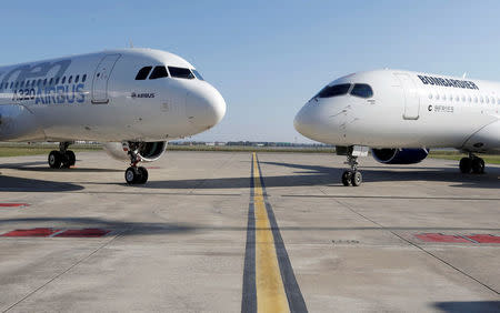 An Airbus A320neo aircraft and a Bombardier CSeries aircraft are pictured during a news conference to announce a partnership between Airbus and Bombardier on the C Series aircraft programme, in Colomiers near Toulouse, France, October 17, 2017. REUTERS/Regis Duvignau