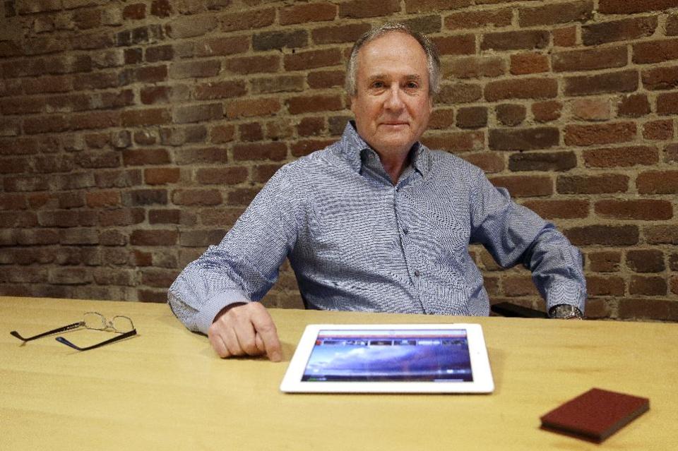 In this Friday, Feb. 21, 2014, photo, Mike Ramsay, CEO of Qplay, poses for photographs after giving a demonstration of Qplay on a tablet device in San Francisco. (AP Photo/Jeff Chiu)