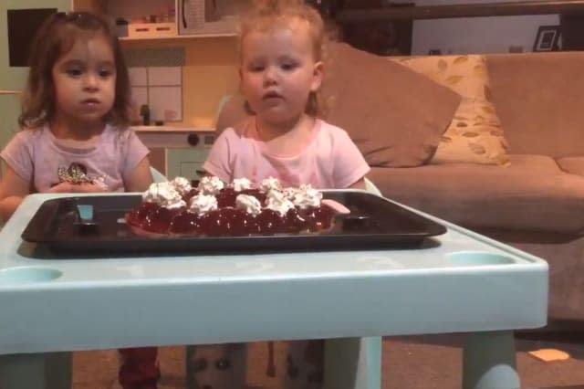 Little girls gobble up dessert right after their mums ask them to wait