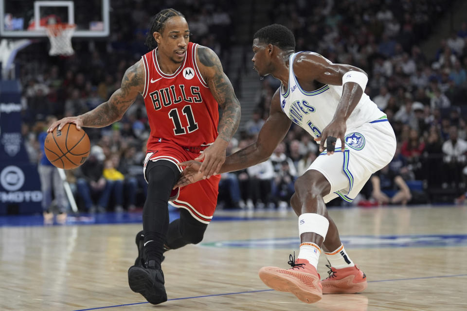 Chicago Bulls forward DeMar DeRozan (11) works toward the basket as Minnesota Timberwolves guard Anthony Edwards (5) defends during the first half of an NBA basketball game, Sunday, March 31, 2024, in Minneapolis. (AP Photo/Abbie Parr)