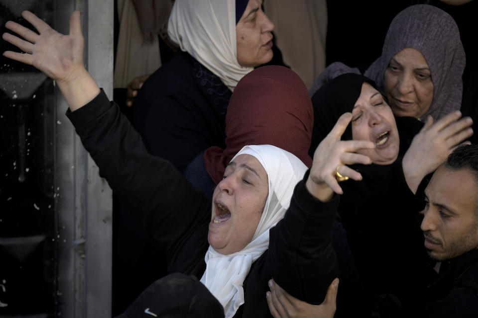 Palestinian women mourn Jawad Bawaqna, 57, and Adham Jabareen, 28, during their funeral in the in the West Bank city of Jenin, Thursday, Jan. 19, 2023. Palestinian officials and media reports say Israeli troops shot and killed a Palestinian schoolteacher and a militant during a military raid in the occupied West Bank. (AP Photo/Majdi Mohammed)