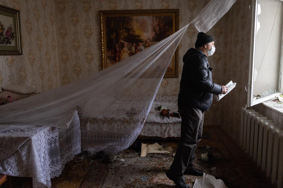 KYIV, UKRAINE - FEBRUARY 25: A man looks out of the window of a damaged apartment in a residential block hit by an early morning missile strike on February 25, 2022 in Kyiv, Ukraine. Yesterday, Russia began a large-scale attack on Ukraine, with Russian troops invading the country from the north, east and south, accompanied by air strikes and shelling. The Ukrainian president said that at least 137 Ukrainian soldiers were killed by the end of the first day. (Photo by Chris McGrath/Getty Images)