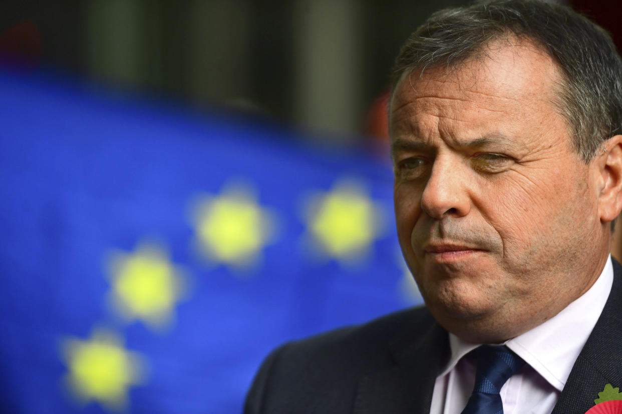 Leave campaigner and businessman Arron Banks, centre,  speaks to the media outside BBC Broadcasting House in London, after appearing on the Andrew Marr show, in London, Sunday, Nov. 4, 2018. Britain's National Crime Agency is investigating a main financial backer of the campaign to get Britain out of the European Union over suspected illegal funding during the country's EU membership referendum, authorities said Thursday. (Victoria Jones/PA via AP)