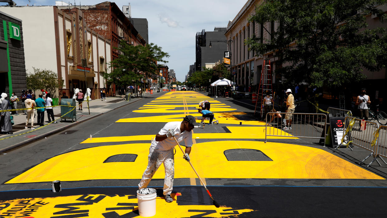 Volunteers work on a Black Lives Matter mural on a Brooklyn street in June as a protest against racial inequality in the aftermath of the death of George Floyd in Minneapolis police custody. (Brendan McDermid/Reuters)