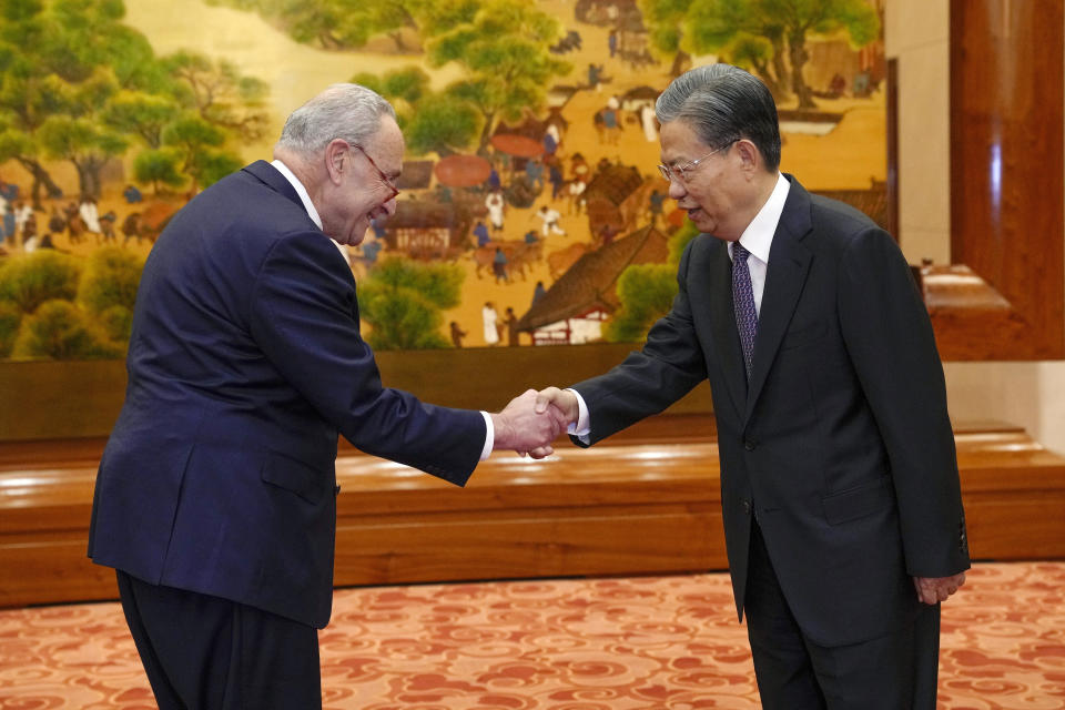 Visiting U.S. Senate Majority Leader Chuck Schumer, D-N.Y., left, is greeted by Zhao Leji, chairman of China's National People's Congress before their bilateral meeting at the Great Hall of the People in Beijing, Monday, Oct. 9, 2023. (AP Photo/Andy Wong, Pool)