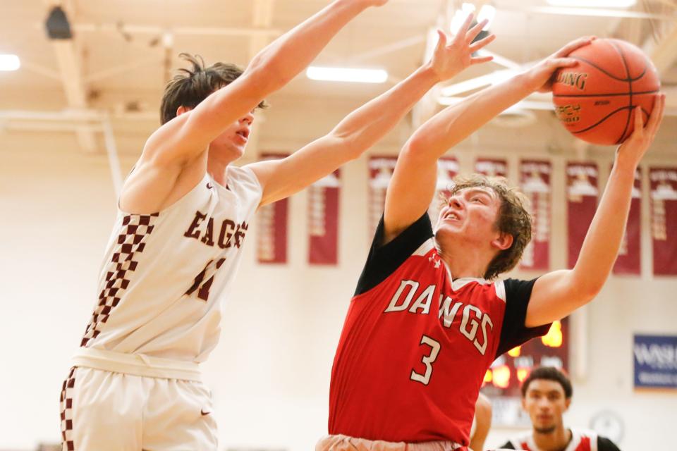 Rossville sophomore Jack Donovan (3) looks for a layup over Silver Lake junior JP Whitehead (12) during the first half of the rivalry matchup Tuesday, Dec. 19, 2023 at Silver Lake High School.