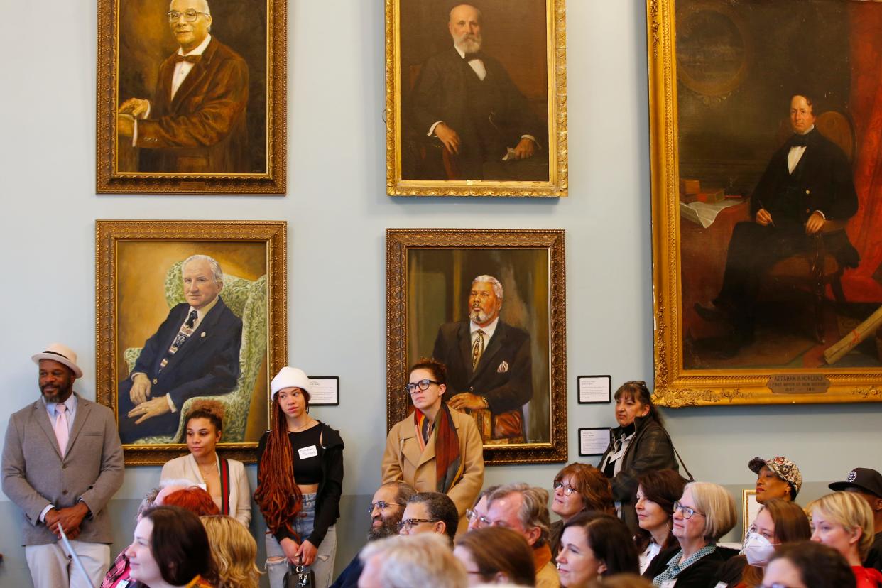 Faces from New Bedford's past, along with those of today, look on during a ceremony held at the downtown New Bedford Public Library where the New Bedford Creative announced the release of eighty two grant awards totaling $509,200.