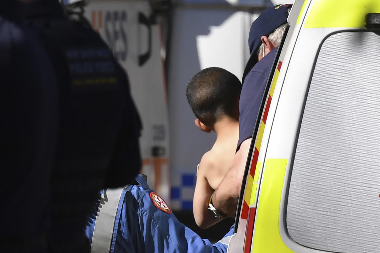 Three-year-old AJ Elfalak is carried by a paramedic into an ambulance after he is found alive on the family property near Putty, north west of Sydney, Australia, Monday, Sept. 6, 2021. AJ was found sitting in a creek and cupping water in his hands to drink three days after he was lost in rugged Australian woodland. (Dean Lewins/AAP Image via AP)