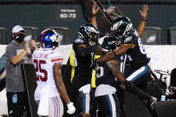 Philadelphia Eagles players celebrate after a touchdown by Boston Scott during the second half of an NFL football game against the New York Giants, Thursday, Oct. 22, 2020, in Philadelphia. (AP Photo/Chris Szagola)