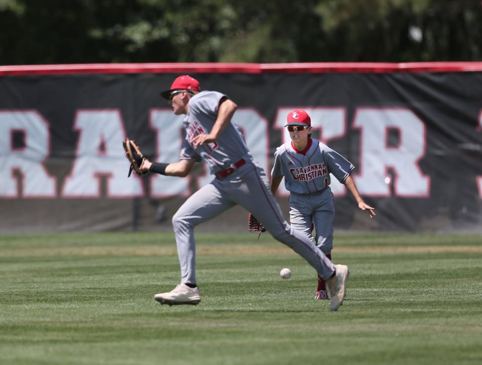 A flyball drops between Savannah Christian right fielder Blaine Burnsed and center fielder Dawson Kelly during Wednesday's state playoff game against Fellowship Christian.