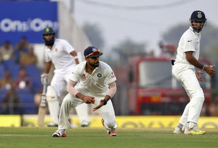 India's captain Virat Kohli (C) fields the ball during the first day of their third test cricket match against South Africa in Nagpur, India, November 25, 2015. REUTERS/Amit Dave